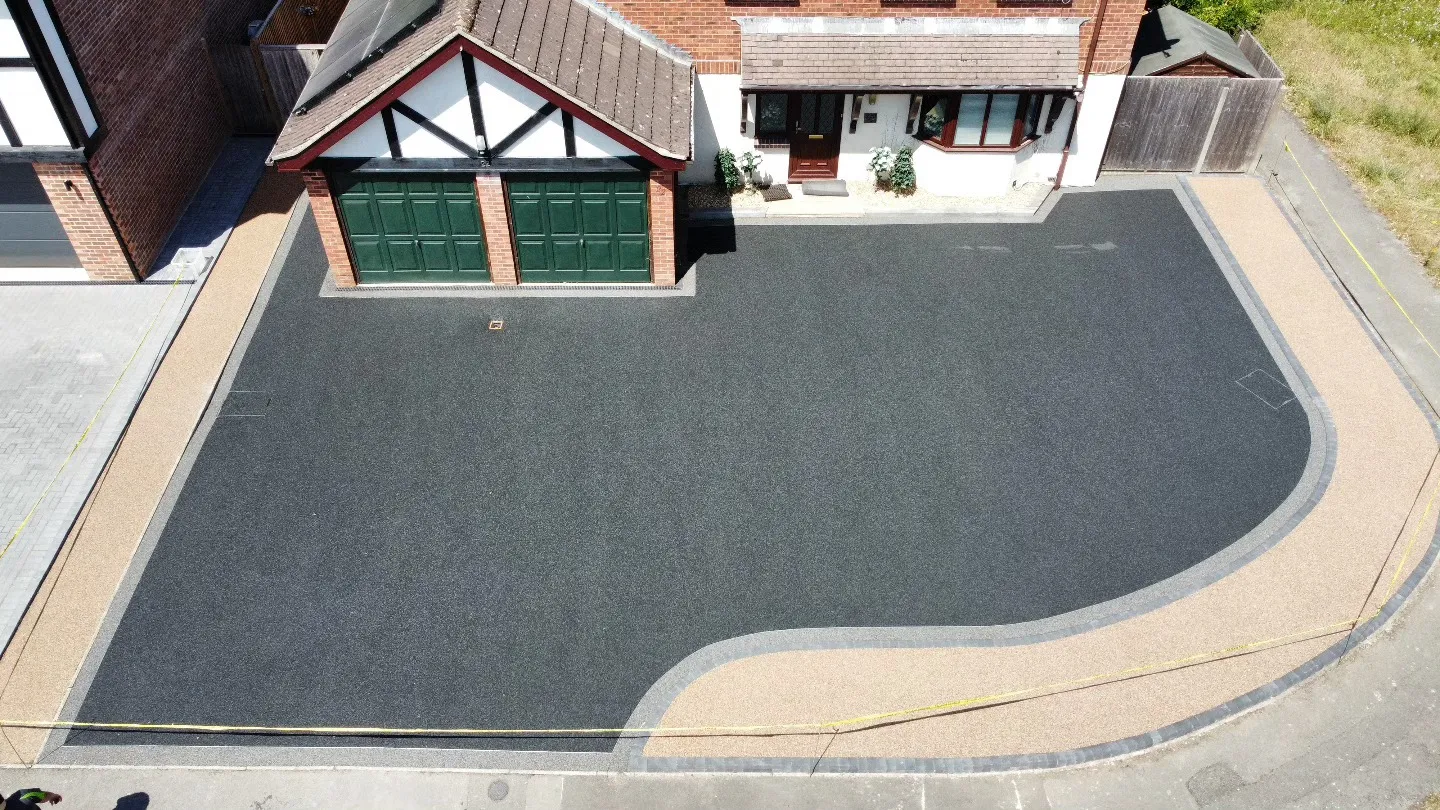 An aerial view of a house with a driveway.