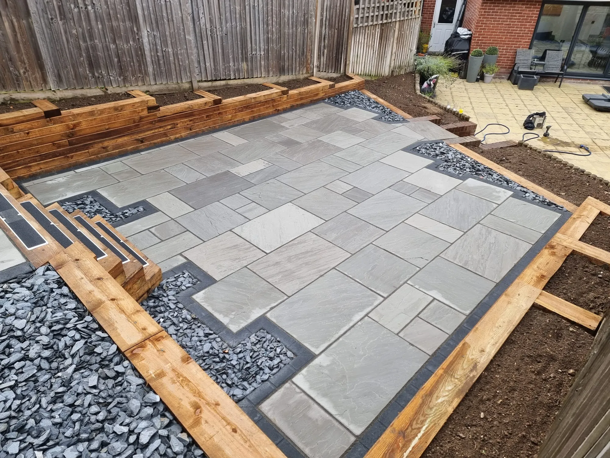 a backyard patio with a raised patio area