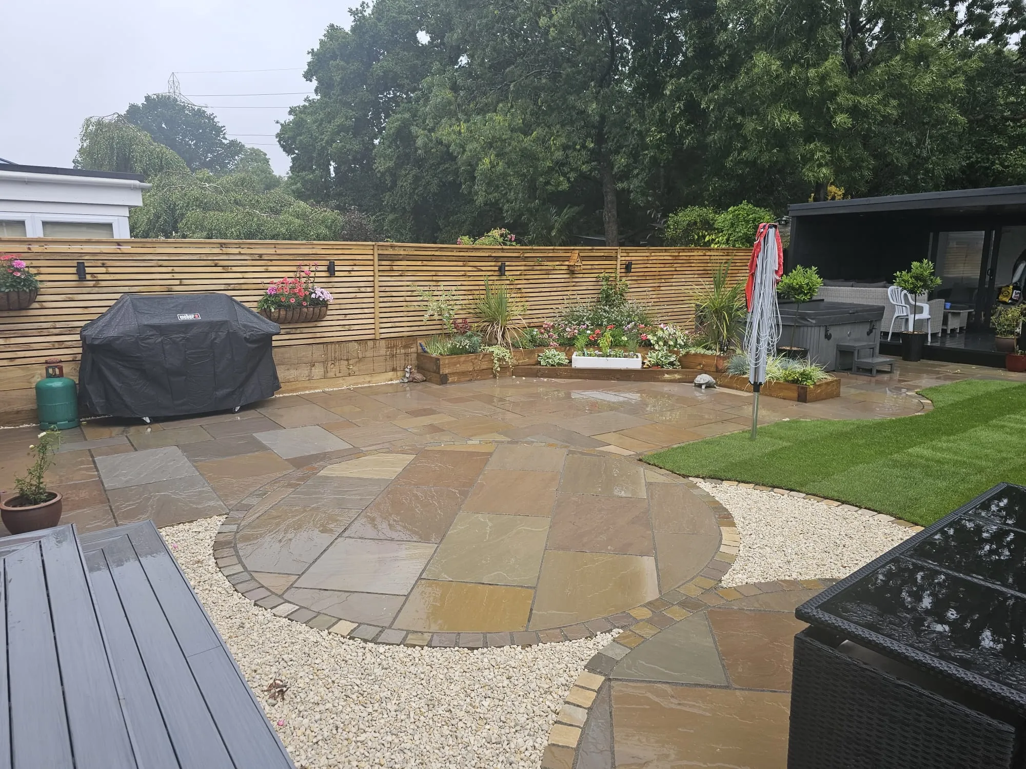 a back yard with a grill and patio furniture