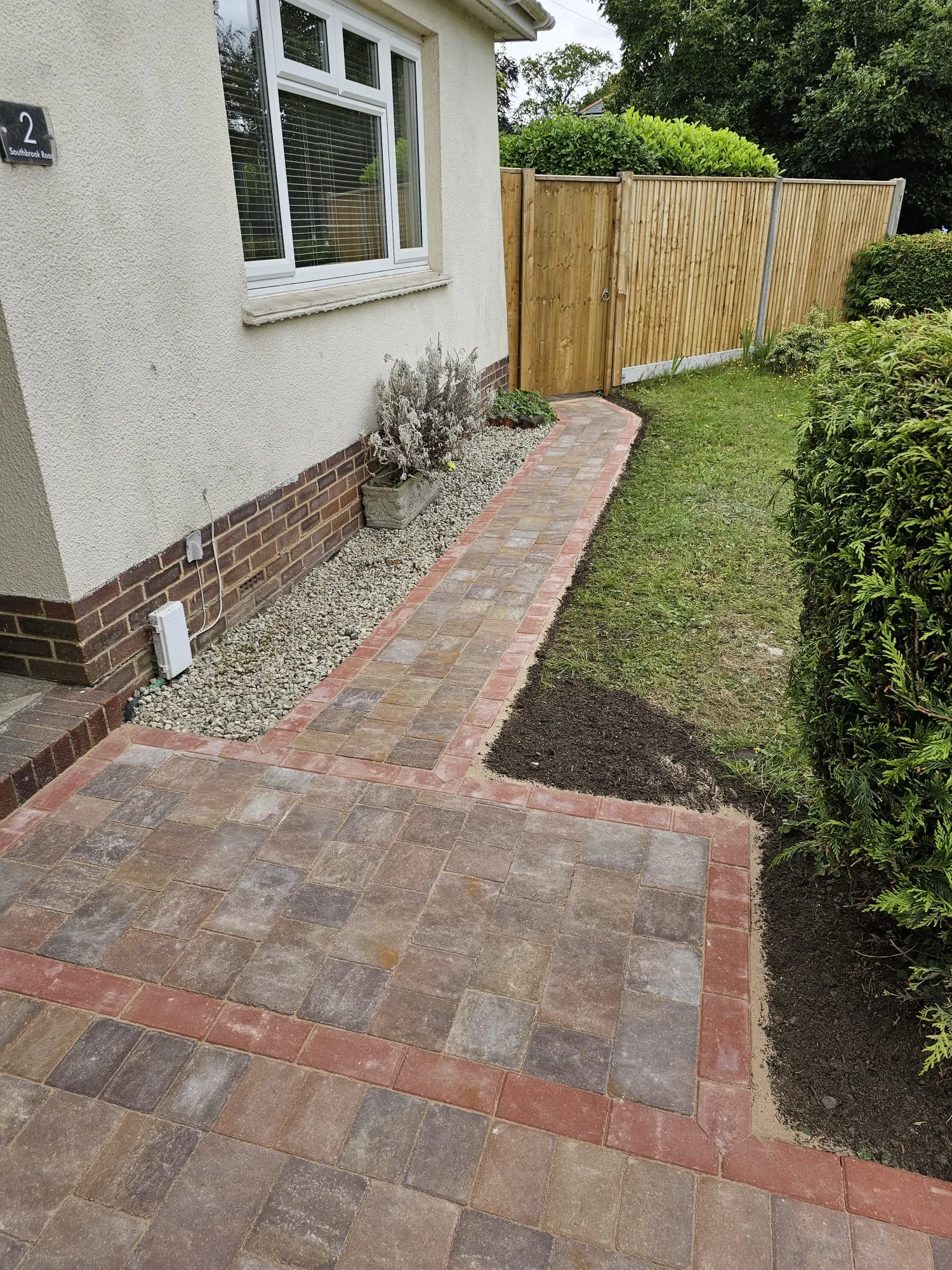 a brick walkway in front of a house