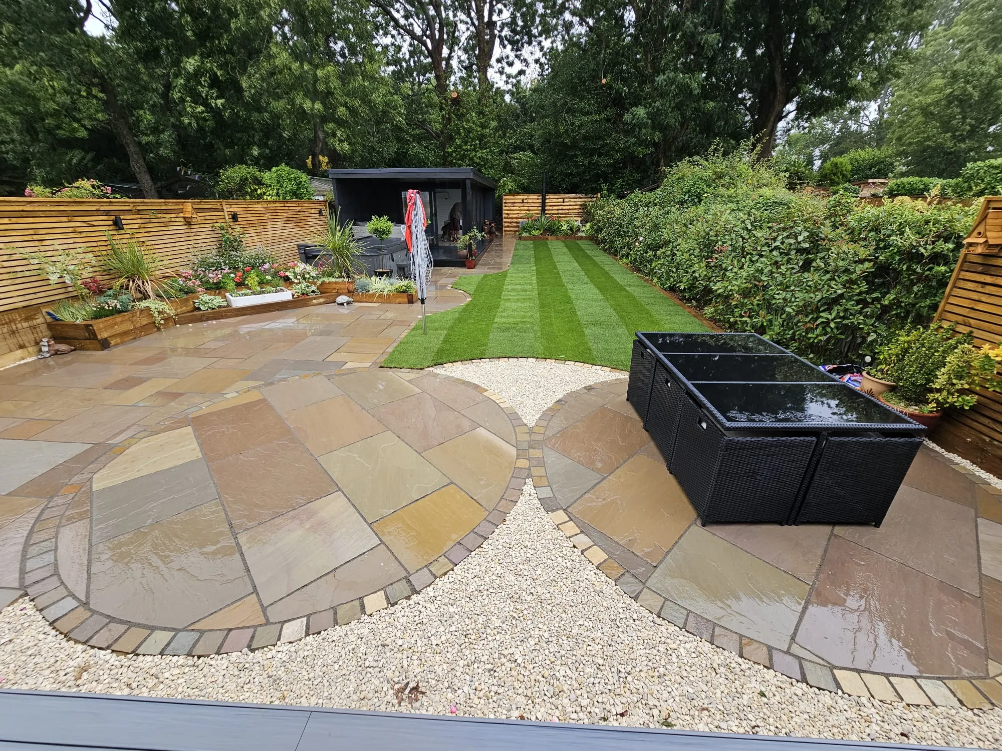 a backyard with a large garden and a small shed