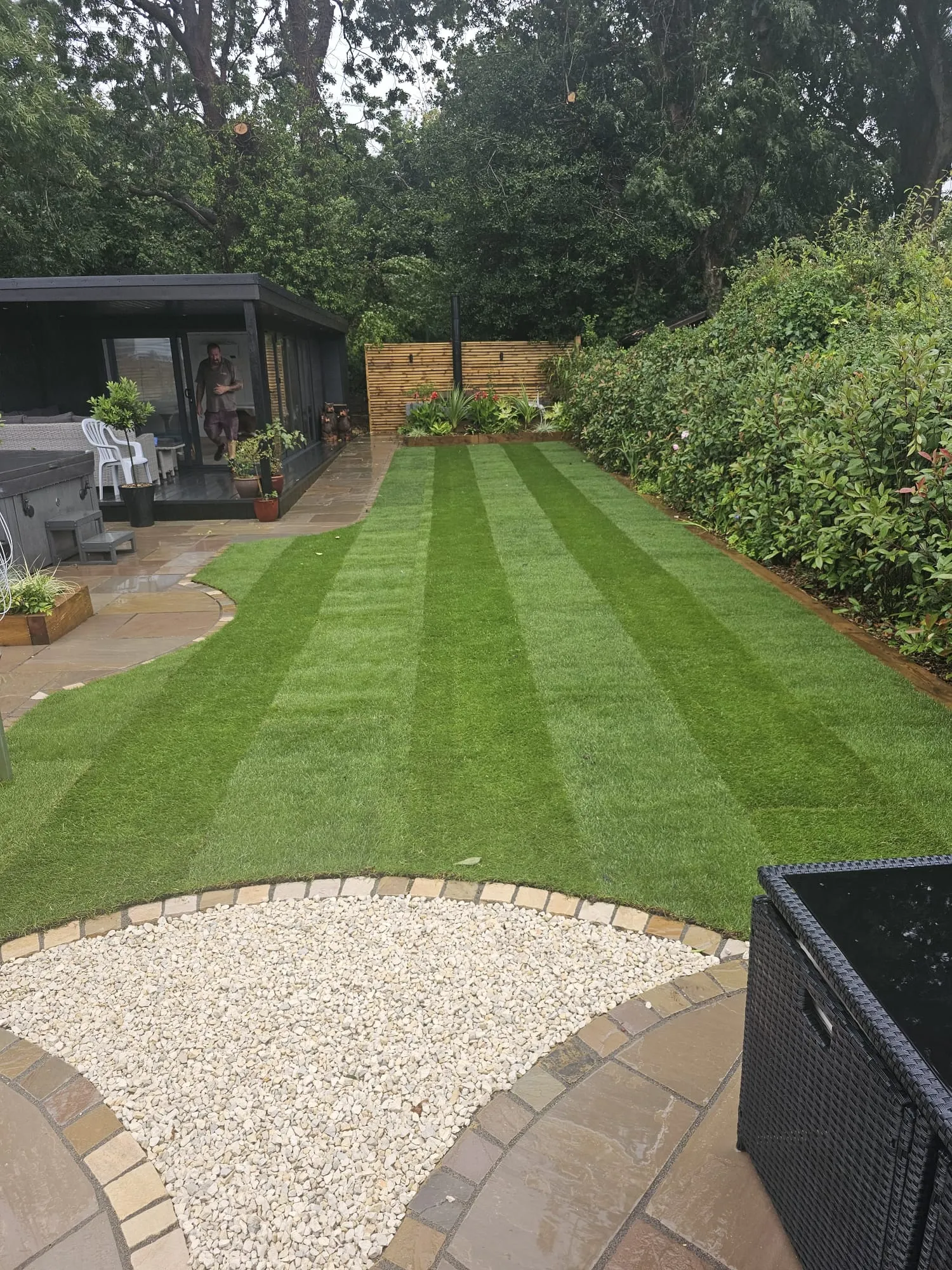 a backyard with a large lawn and landscaping